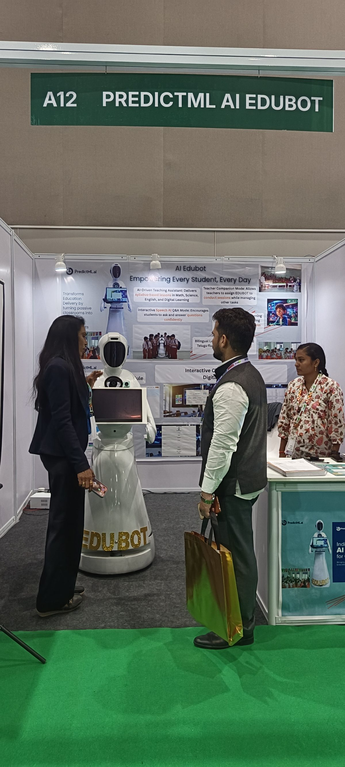 The PredictML exhibition stand, the robot standing in front of a display board describing its classroom features